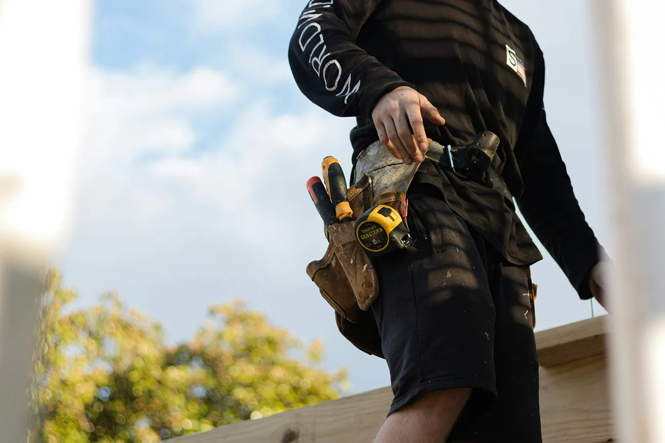 Contractor with a tool belt on site